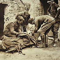Arrival of wounded soldier on stretcher who's being examined by officers and doctor at first aid post in Flanders during the First World War, Belgium.