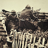Belgian soldiers in trench shooting with rifle and machine gun at German enemies in Flanders during the First World War, Belgium