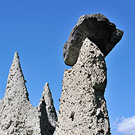 The Pyramids of Euseigne in the canton of Valais, Switzerland. Rocks of harder stone stacked on top protect the columns from rapid erosion, creating these pyramidal rock formations