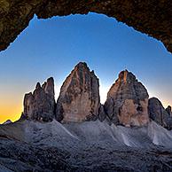 Tre Cime di Lavaredo / Drei Zinnen, three distinctive mountain peaks in the Sexten Dolomites seen from WW1 cave shelter, South Tyrol, Italy